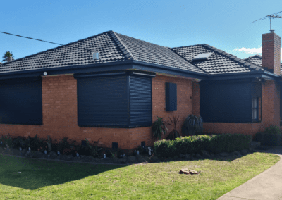 home with black roller shutters